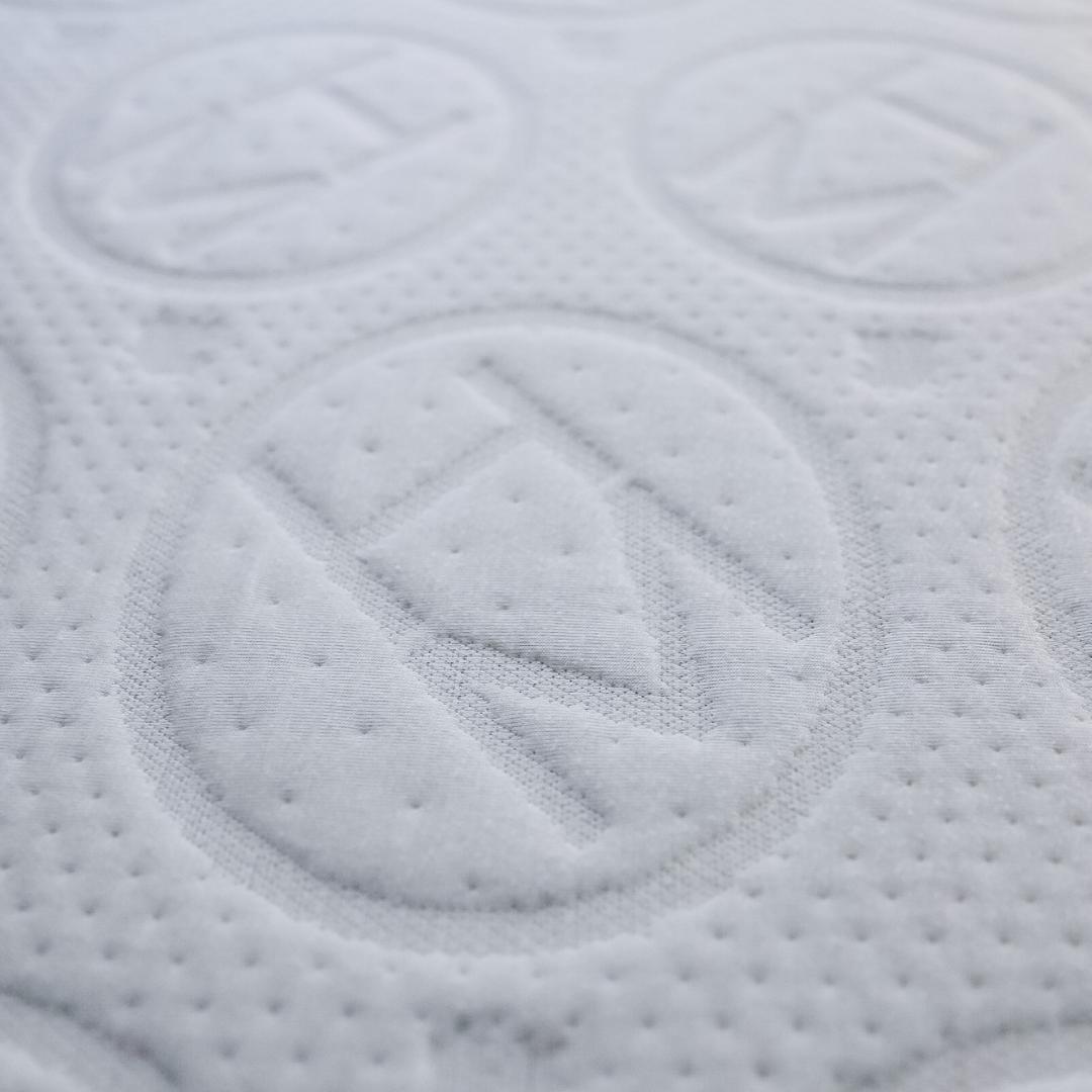 close up of haven jr 6" mattress with embossed logo. Bed materials are all plant based